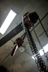 Low angle view of chain hanging on wall