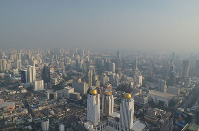 Aerial view of modern buildings in city against clear sky