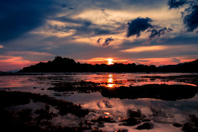 Scenic view of dramatic sky over sea during sunset