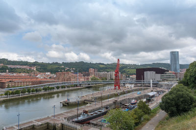 High angle view of bridge and buildings against sky