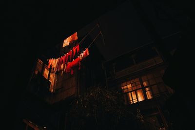 Low angle view of illuminated building against sky at night