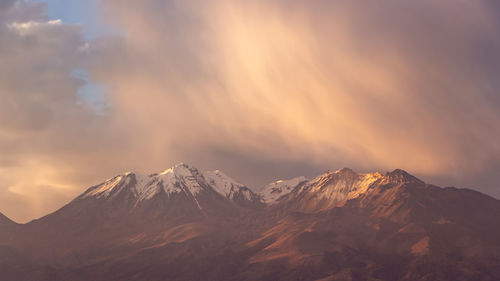 Scenic view of snowcapped mountains against sky during sunset