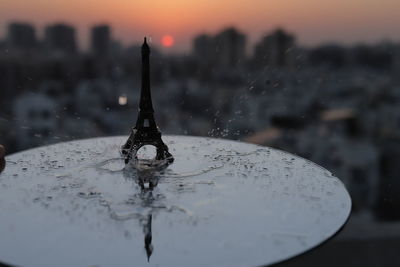 Close-up of water splashing against sky at sunset