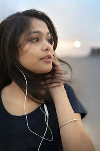 Portrait of young woman looking at camera