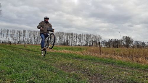 Man riding bicycle on grass