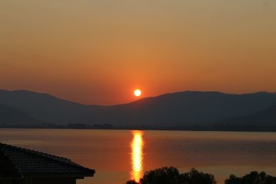 Scenic view of lake against romantic sky at sunset