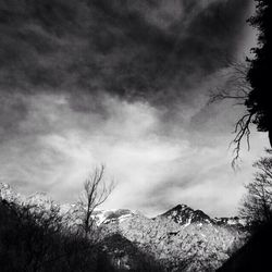 Scenic view of mountains against cloudy sky