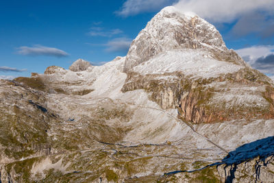 Panoramic view of the mangart mountain range in the julian alps with mountain pass road, slovenia.