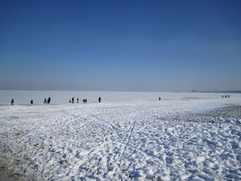 Scenic view of frozen field against clear sky