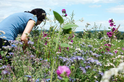 Woman working on field against sky