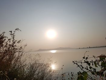 Scenic view of lake against sky during sunset