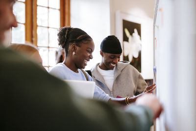 Side view of man using digital tablet while sitting at home