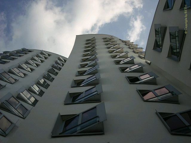 LOW ANGLE VIEW OF MODERN BUILDINGS AGAINST SKY