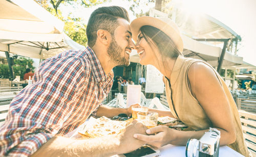 Close-up of couple kissing at outdoor restaurant