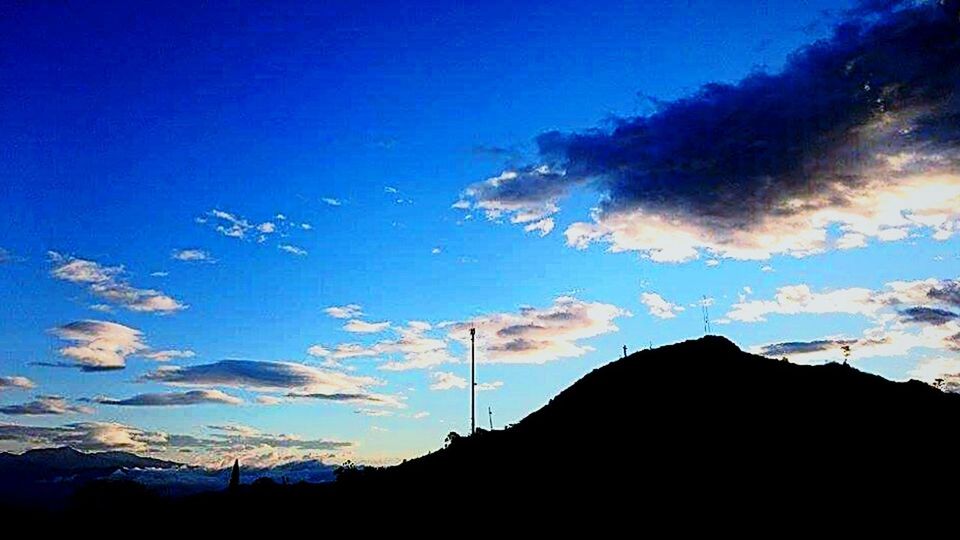blue, silhouette, sky, beauty in nature, low angle view, scenics, cloud - sky, tranquility, tranquil scene, nature, mountain, cloud, dusk, sunset, outdoors, landscape, idyllic, no people, majestic, mountain range