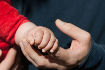 Baby hand holding dad's hand
