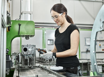 Young woman working on a machine