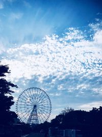 Low angle view of ferris wheel against sky