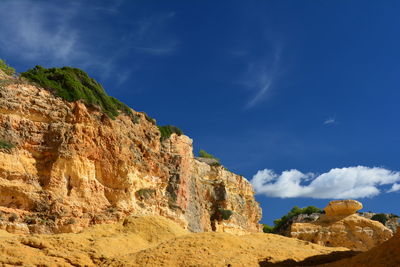 Low angle view of rock formation against sky