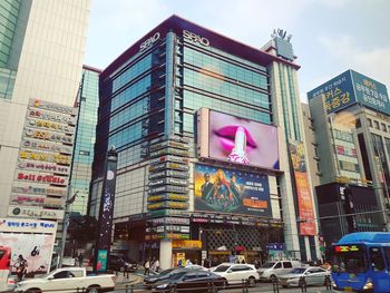 View of city street and buildings against sky