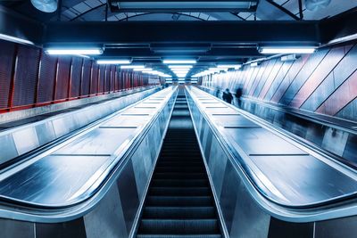 Escalator in illuminated tunnel