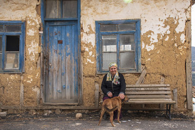 Portrait of man with dog sitting on seat