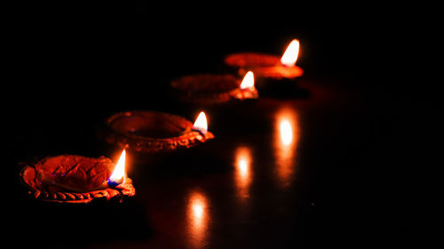 Close-up of lit candles in the dark