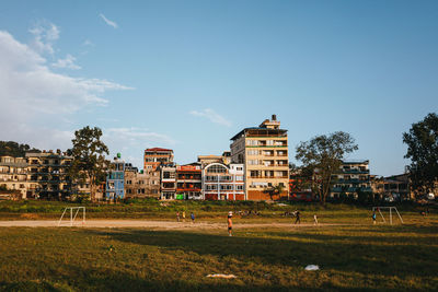 Houses on field against sky