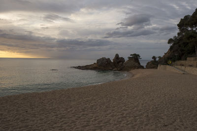 Scenic view of beach against sky during sunset