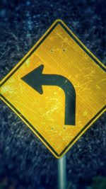 Close-up of arrow sign on wall