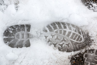 High angle view of footprints on snow covered land