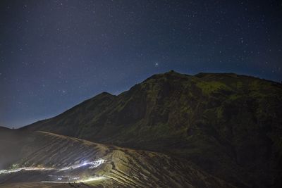 Scenic view of mountains against sky at night