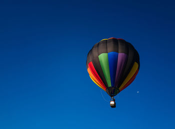 Low angle view of hot air balloon against blue sky