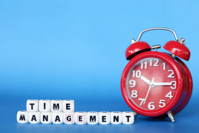 Close-up of clock against blue background