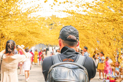 Rear view of people looking at camera