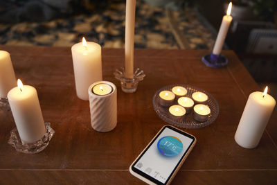 Candles and phone with temperature app