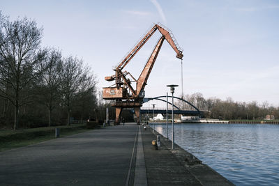 View of pier by river against sky