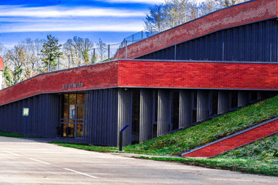 Road by building against sky