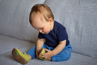 Portrait of adorable little baby sitting on a sofa