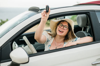 Portrait of young woman in car