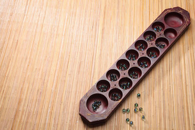 High angle view of marble balls in wooden containers on table