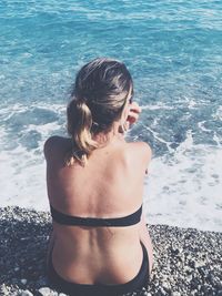 Rear view of woman in bikini on beach