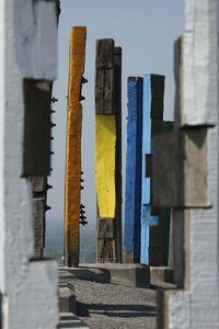 Low angle view of clothesline hanging by building against sky