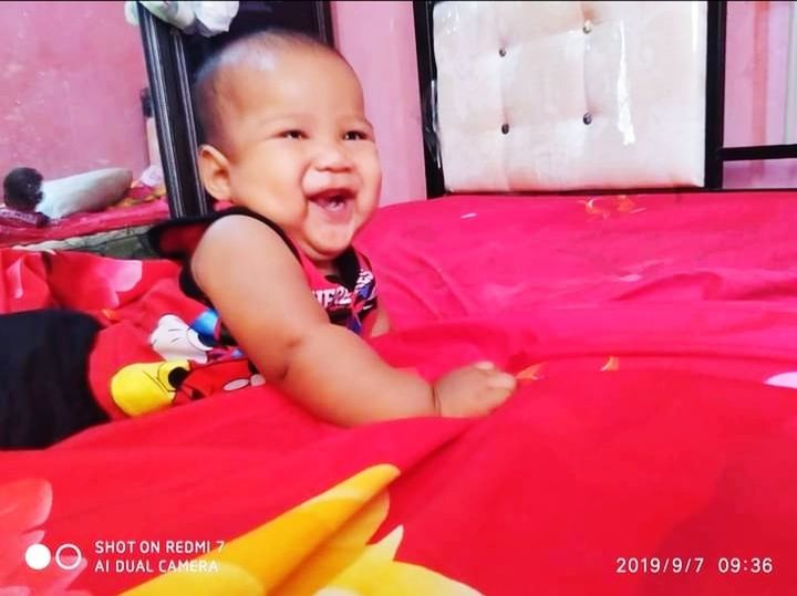 child, childhood, baby, one person, happiness, innocence, smiling, cute, emotion, portrait, toddler, babyhood, person, indoors, baby clothing, cheerful, looking at camera, lifestyles, clothing, toy, sitting, full length, red, fun, waist up, day