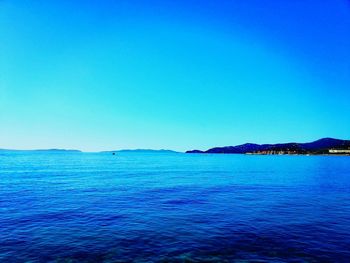 Scenic view of sea against clear blue sky