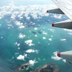 Close-up of airplane flying over snow covered landscape