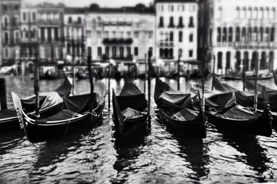 Boats in canal along buildings