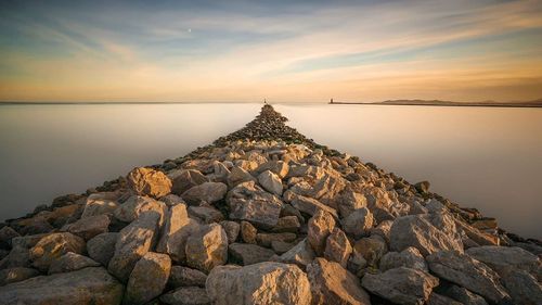 Scenic view of lake against sky during sunset