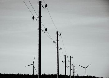 Low angle view of electricity pylon against sky