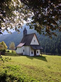 Built structure on field against sky